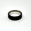 Ebony ring blank lying flat, showing the stainless steel inner core
