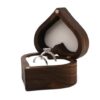 Heart-shaped wooden ring box with white cushions holding two rings