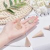 Wooden cone ring stands shown in a hand and on a table
