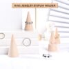 Wooden cone stands displaying rings on stepped display blocks