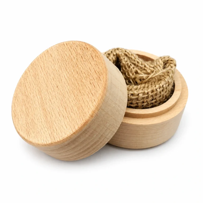 Open round beech wooden ring box with jute interior on a white background