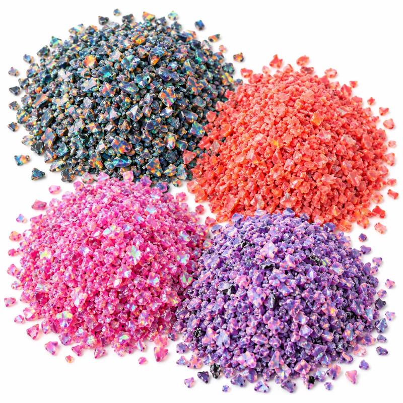Four piles of colourful crushed opal chips in blue, coral, pink and purple on a clean white background.
